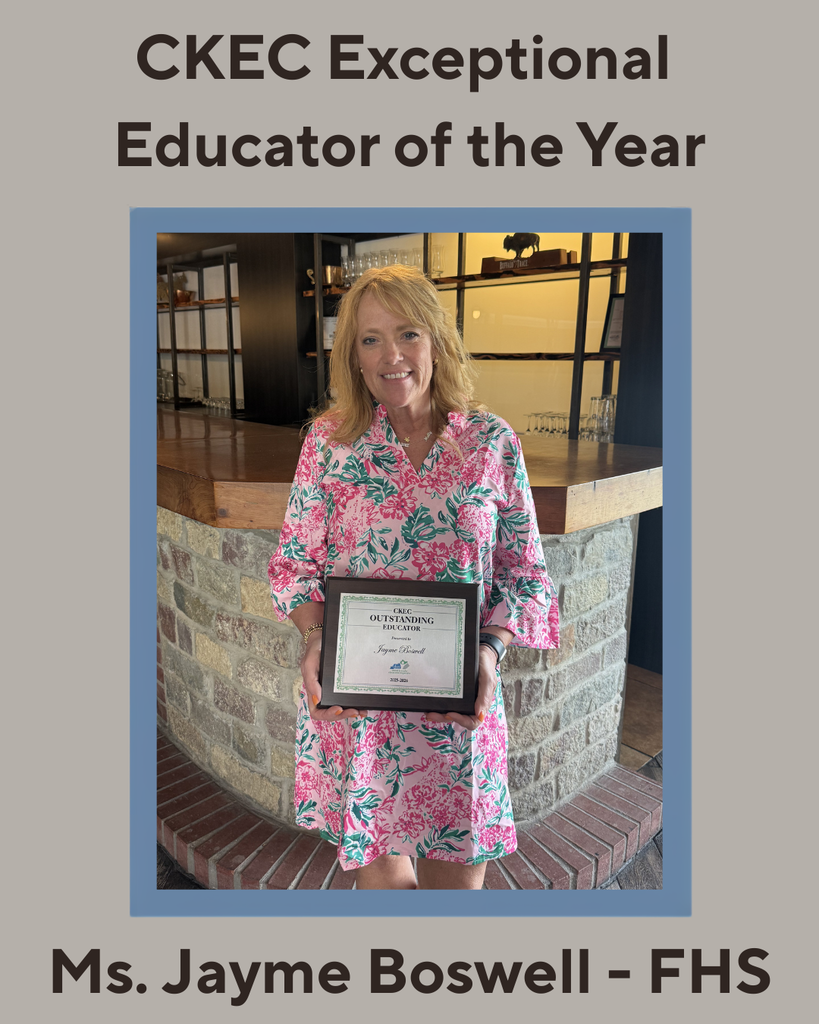 A teacher holding an award certificate