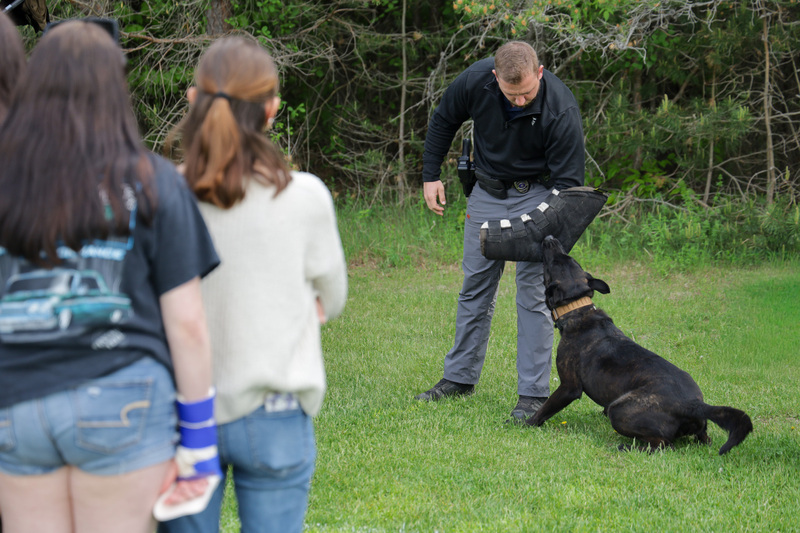 Malone PD agent speaking with student