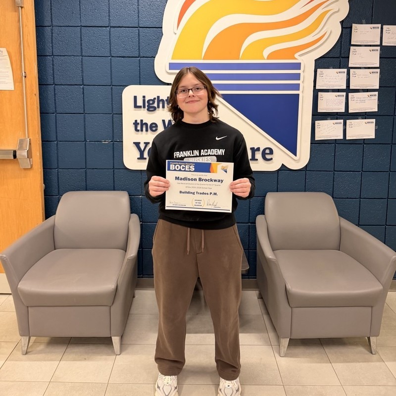 Madison Brockway holds award