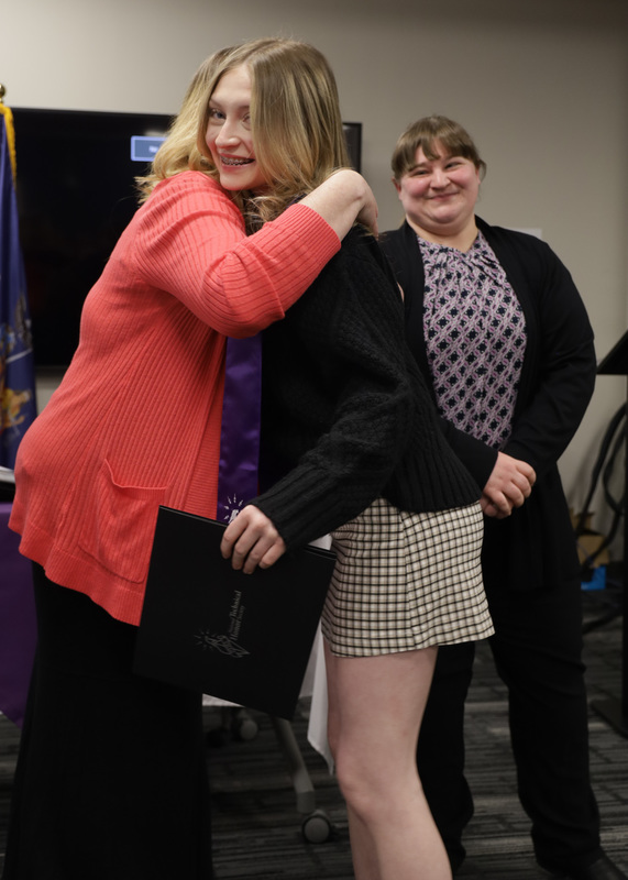 Inductee hugging instructor