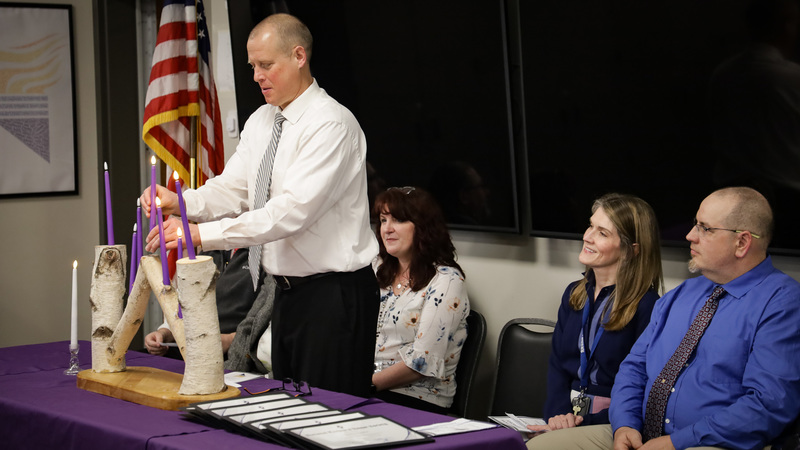 Program instructors lighting the ceremony candles