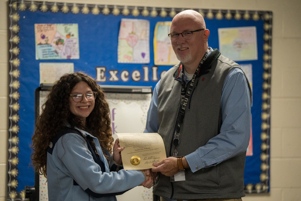 Alya Tolentino receiving an award from Mr. Enoch Welch