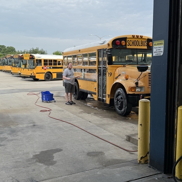 bus driver washing the bus