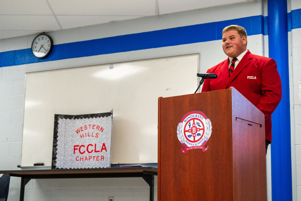 Carter stands at podium in BMS library