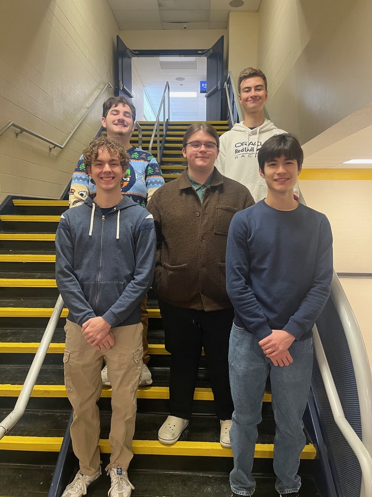 Students posing in stairwell