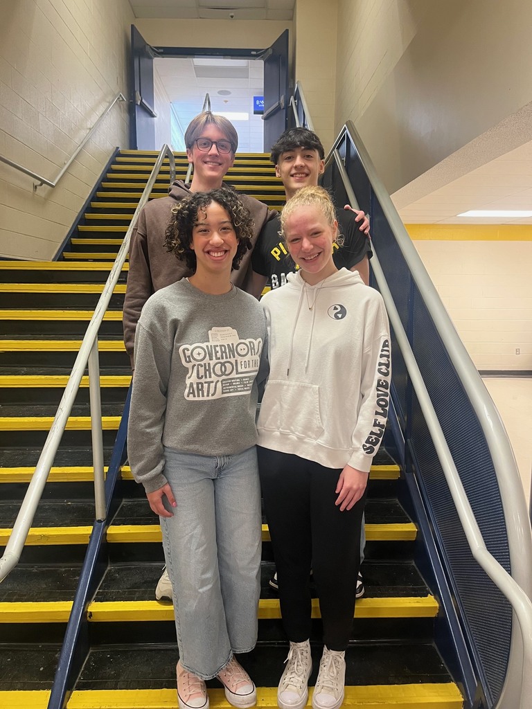 Students posing in stairwell 
