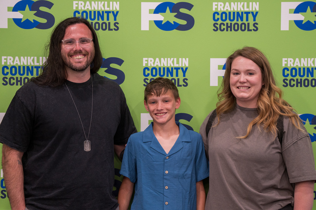 Ryker with Family in FCS Board Room