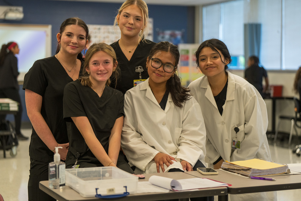 Phlebotomy students practice drawing blood from local volunteers and their peers.