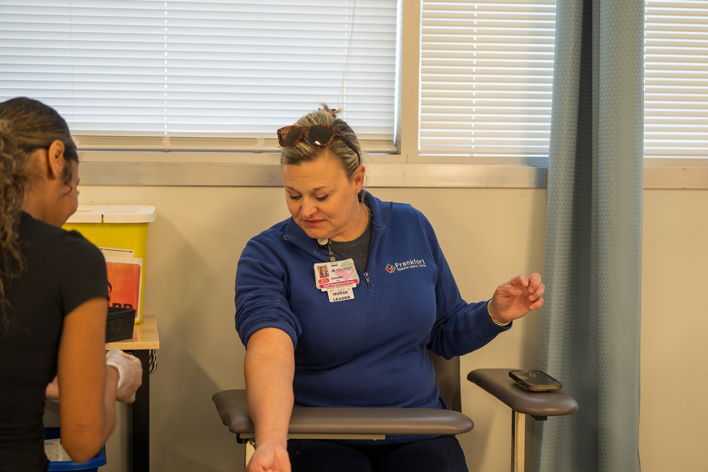Phlebotomy students practice drawing blood from local volunteers and their peers.