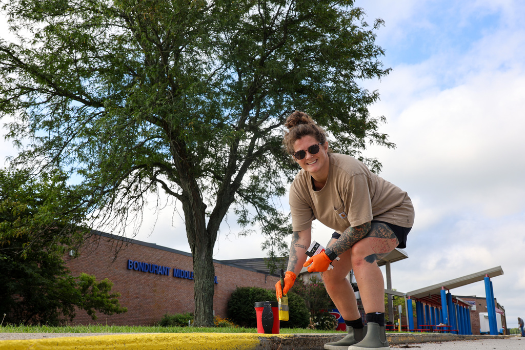 Students and staff at Bondurant Middle School teamed up to get the school looking its best.