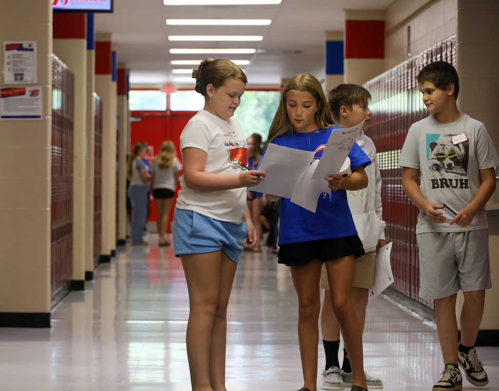8th grade student assists 6th grade student with finding her classes.