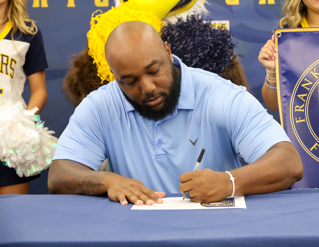New Assistant Principal Ryan Timmons signs the Flyer Commitment.