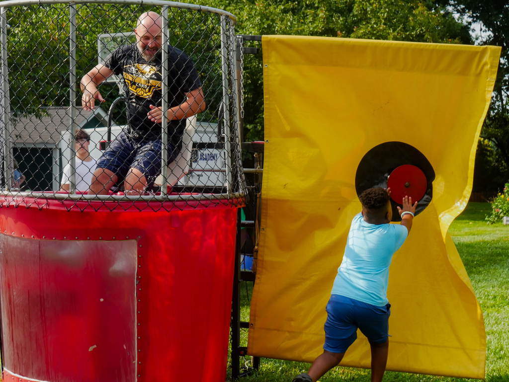 Principal Sheridan gets dunked in the dunk tank.
