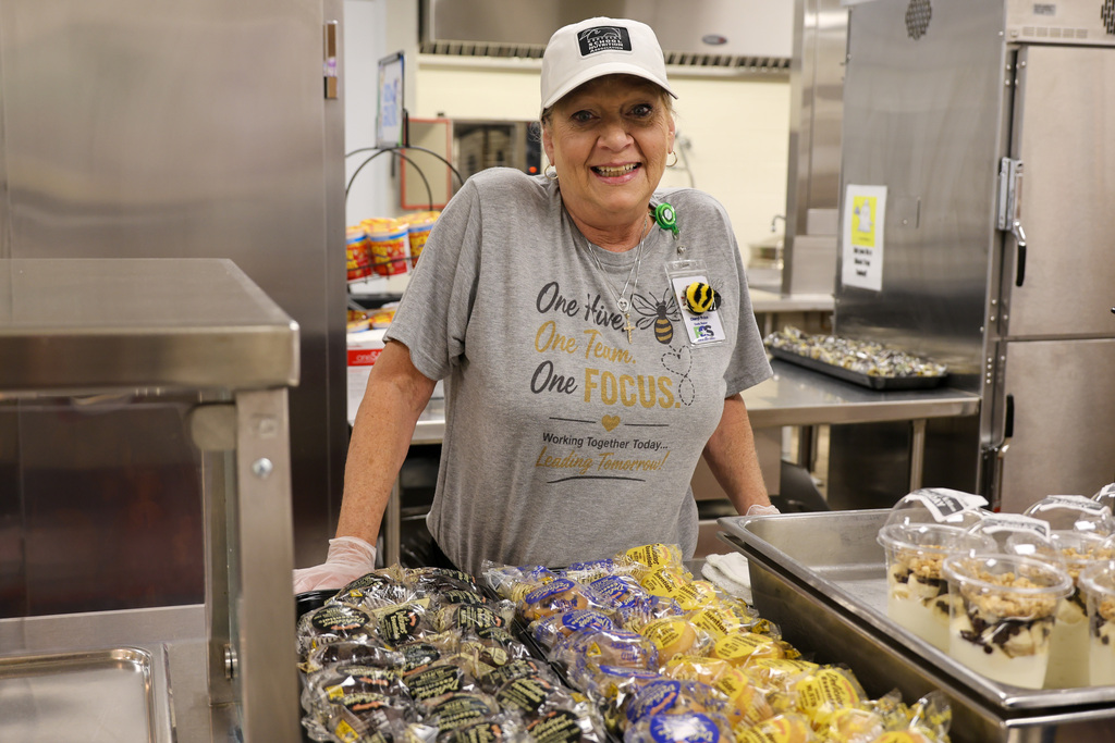Collins Lane Elementary Food Services employee smiles in the kitchen.