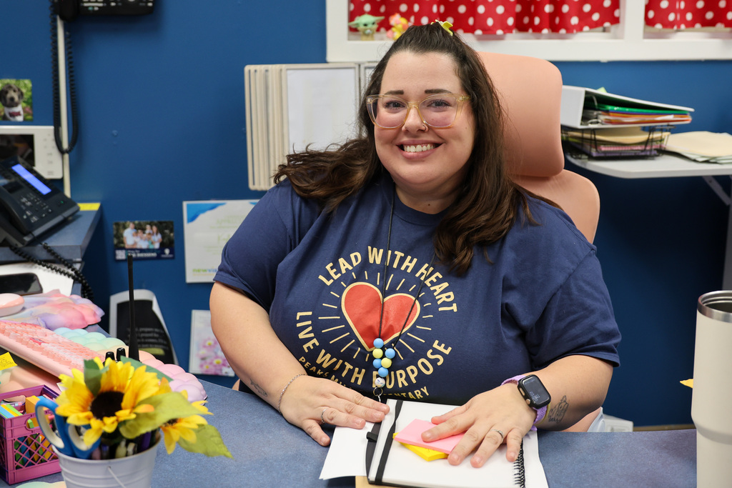 Peaks Mill Elementary Secretary smiles for a photo.