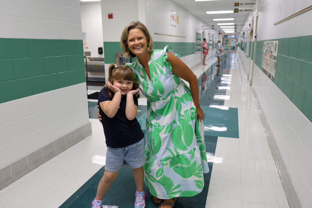 Bridgeport Elementary teacher and student smile in the hallway.