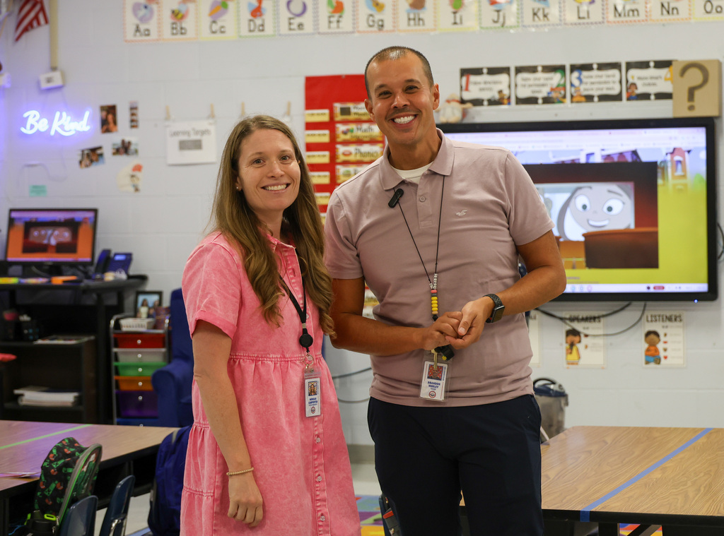 ELV staff members smile in a classroom.