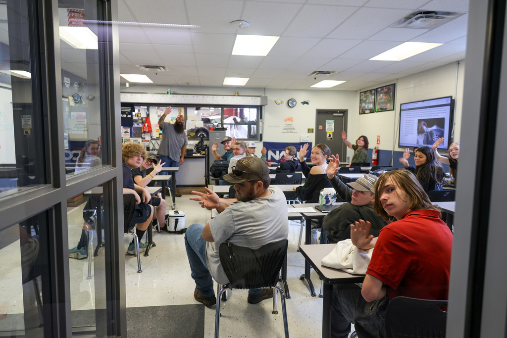 CTC Automotive Class waves to the camera in their classroom.