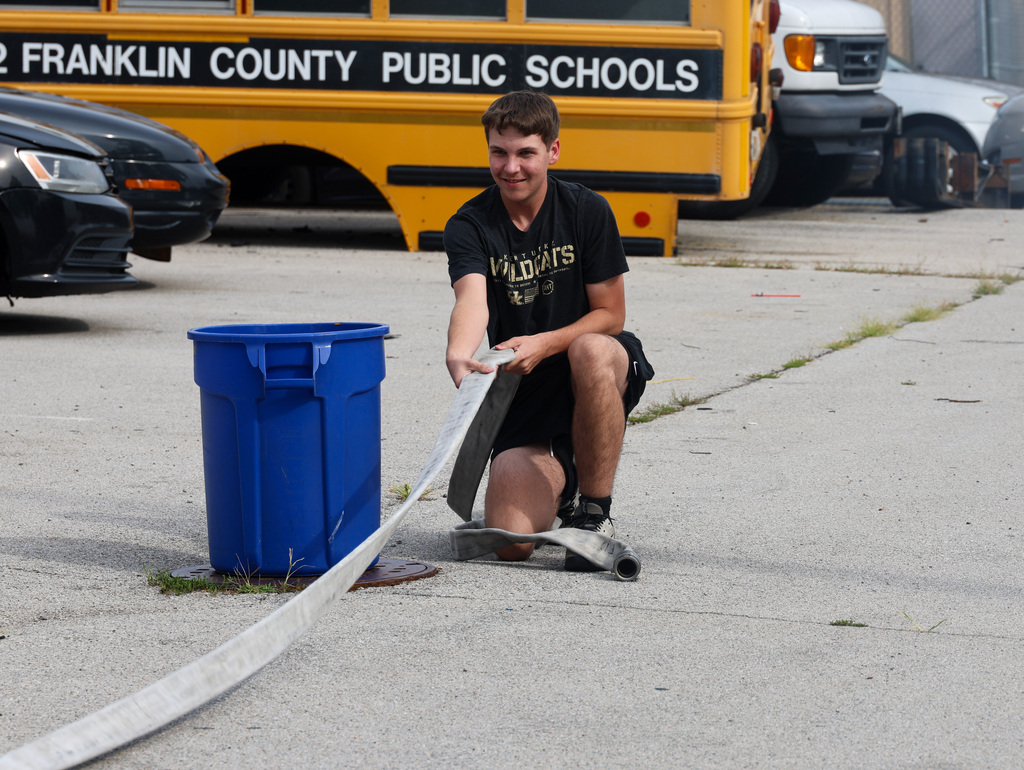 Fire Science student does PT test by pulling a fire hose.