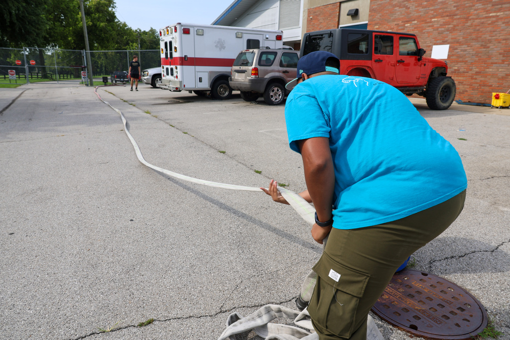 Fire Science student does PT test by pulling a fire hose.