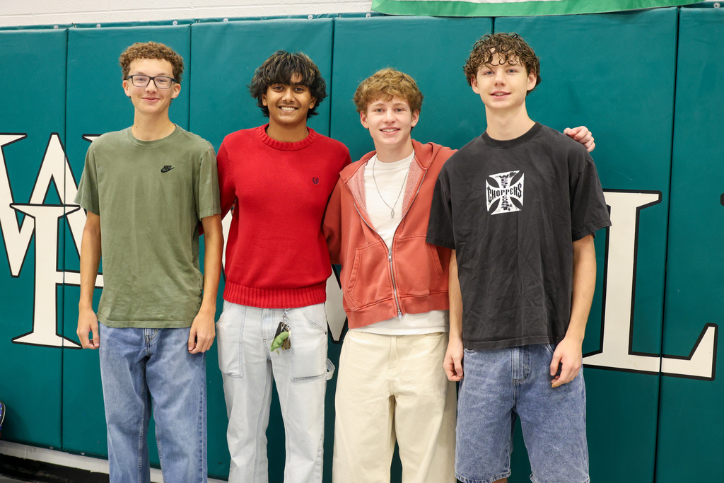 Four WHHS students smile for a photo.