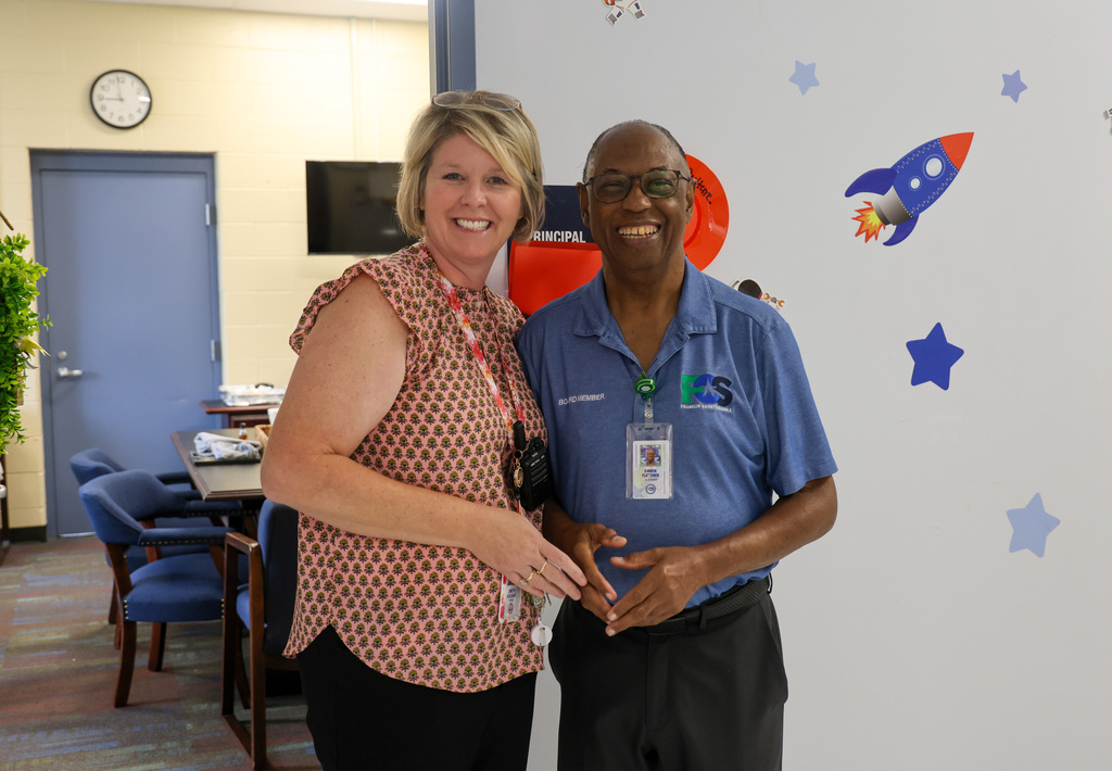 Principal Lynette McKinney (left) stands with board member Chuck Fletcher (right)