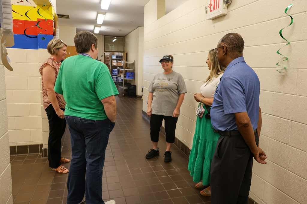 Board members and ELV staff speak with the Food Service Manager.