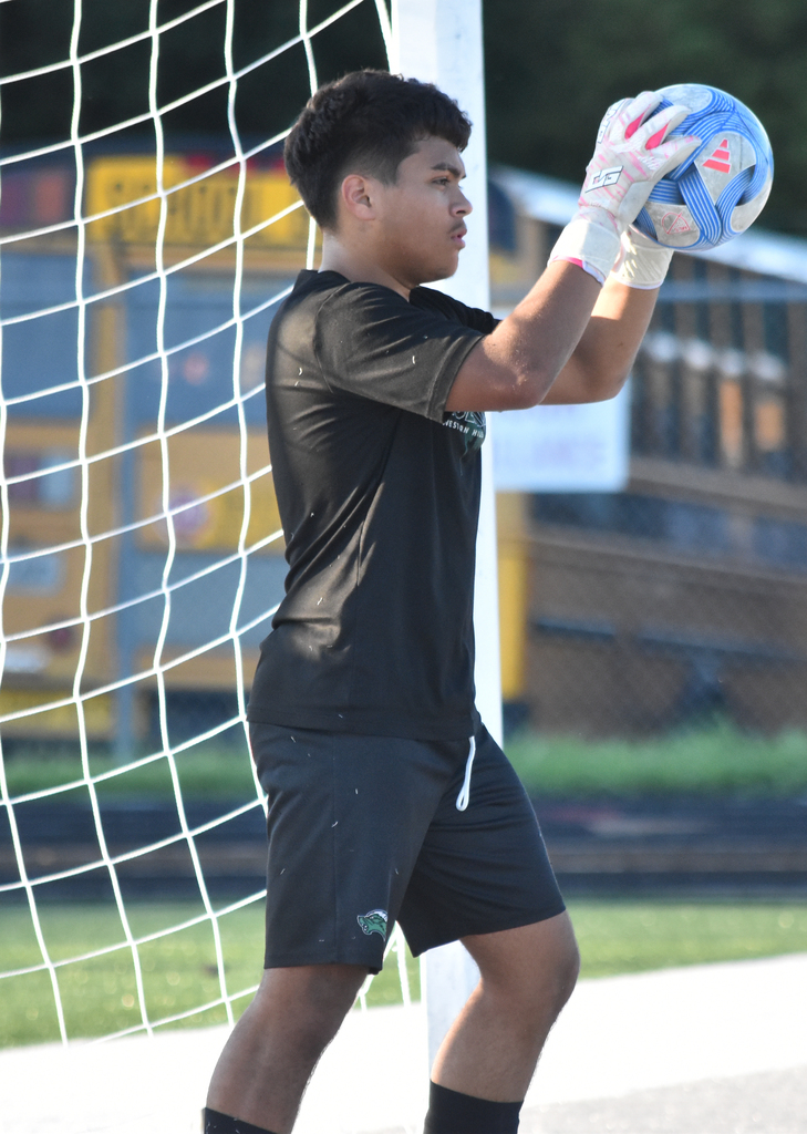 WHHS goalie prepares to throw the soccer ball back into play.