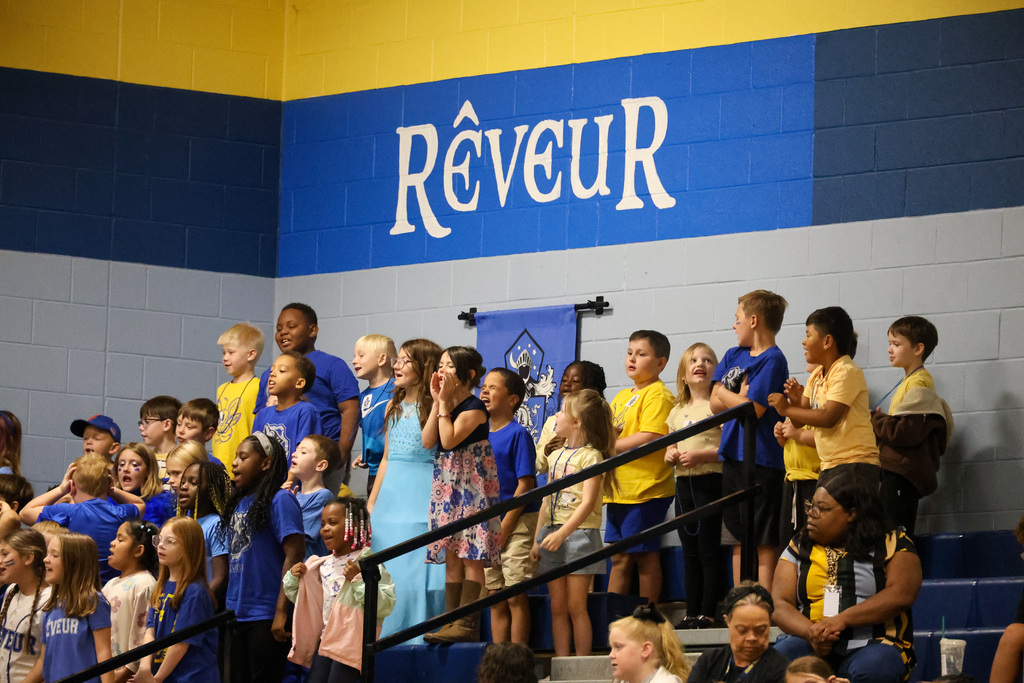 Reveur student section stands and cheers.