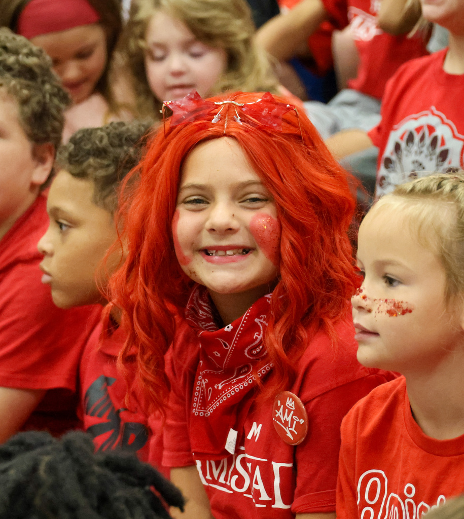 Student smiles dressed in all red.