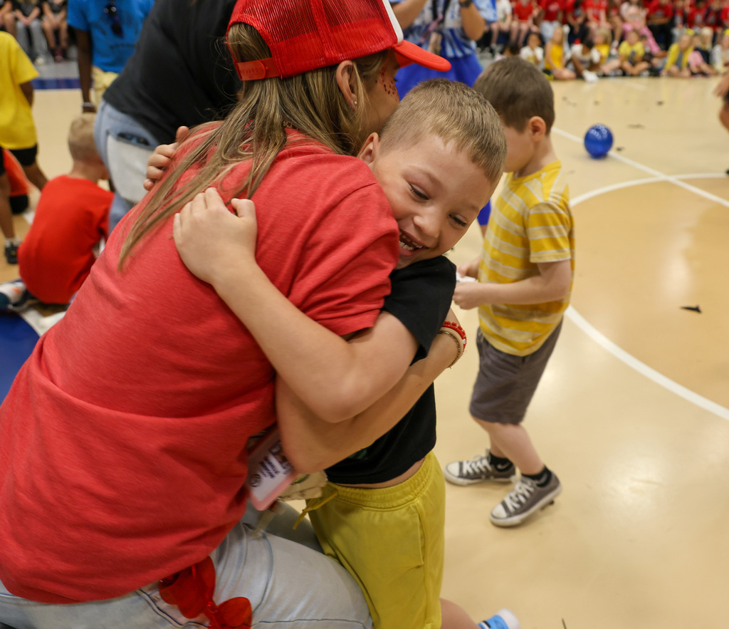 Student hugs staff member after finding out his nest.