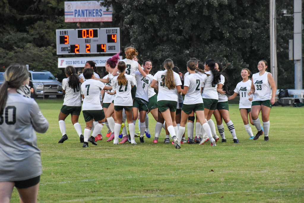 WHHS team celebrates after winning the game.