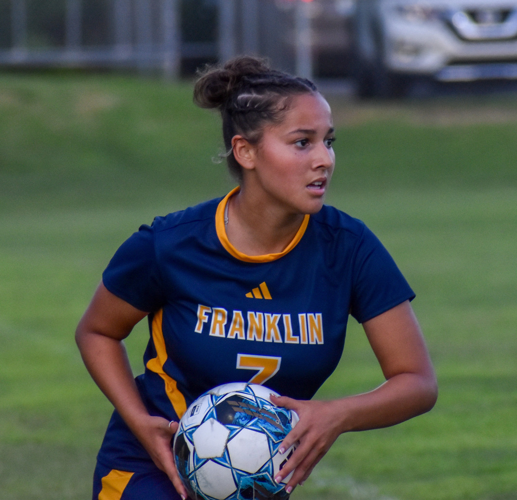 FCHS player prepares to throw the soccer ball back into play.
