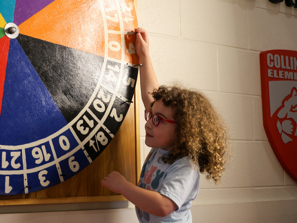 Student spins the wheel to determine which house she will be in.