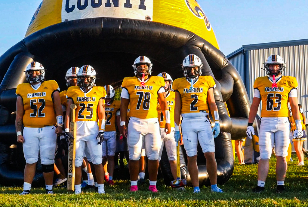 FCHS football team prepares to run onto the field.