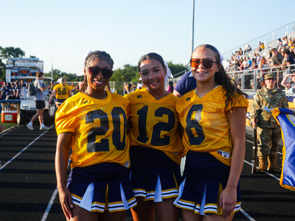Three FCHS cheerleaders stand together for a photo.