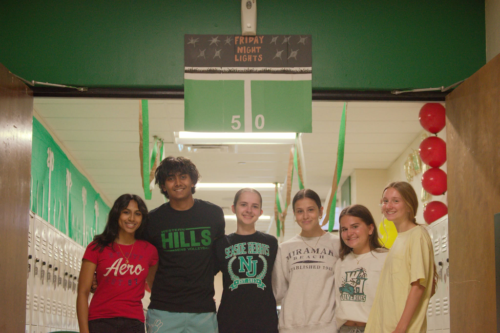 Group photo of students standing in front of their "Friday Night Lights" hallway.