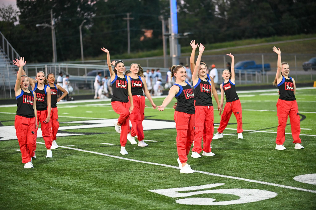 BMS dance team waves on the field.