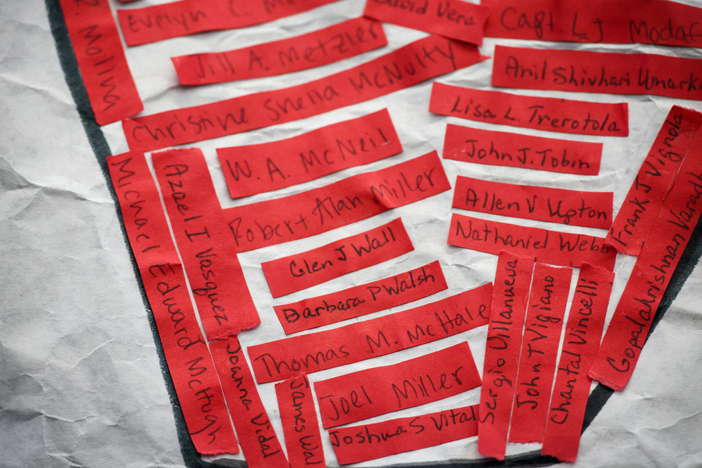 Red strips have a handwritten name of a victim from 9/11.