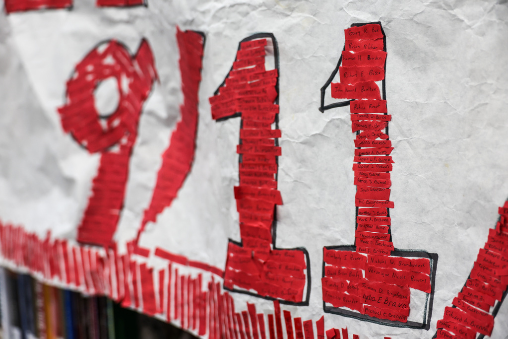 Red strips have a handwritten name of a victim from 9/11.