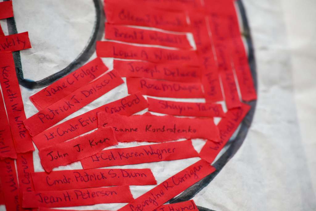 Red strips have a handwritten name of a victim from 9/11.