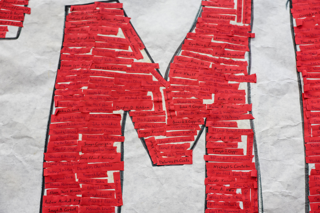 Red strips have a handwritten name of a victim from 9/11.