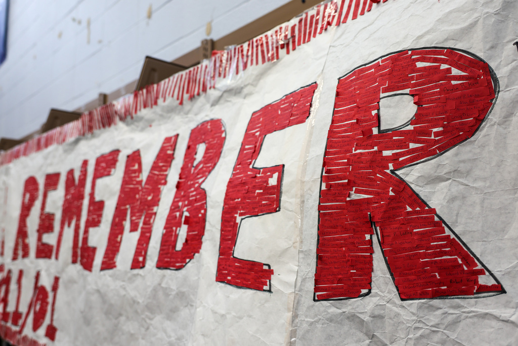 Red strips have a handwritten name of a victim from 9/11.