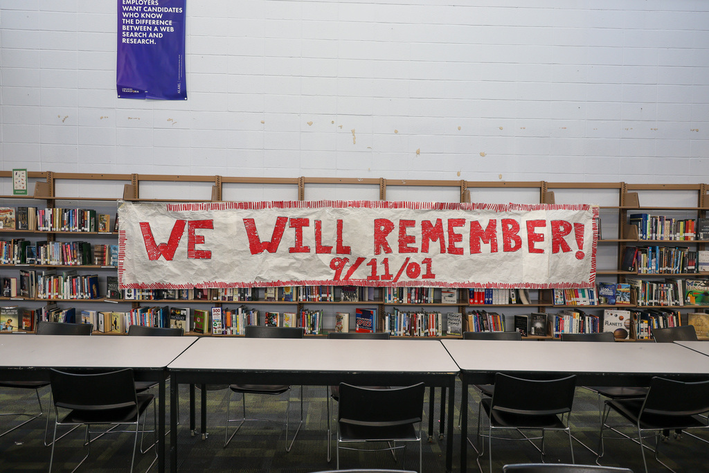 WHHS "We Will Remember" sign hangs in the library.