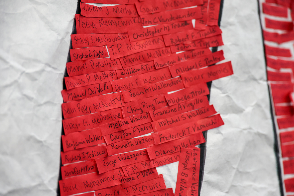 Red strips have a handwritten name of a victim from 9/11.