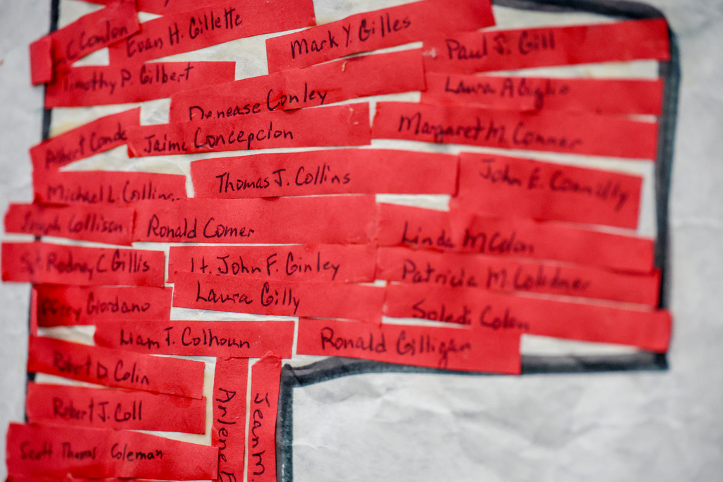 Red strips have a handwritten name of a victim from 9/11.