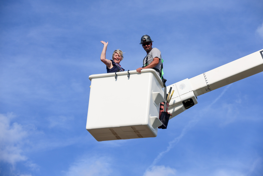 Principal McKinney is in an electrical truck's bucket in the sky.