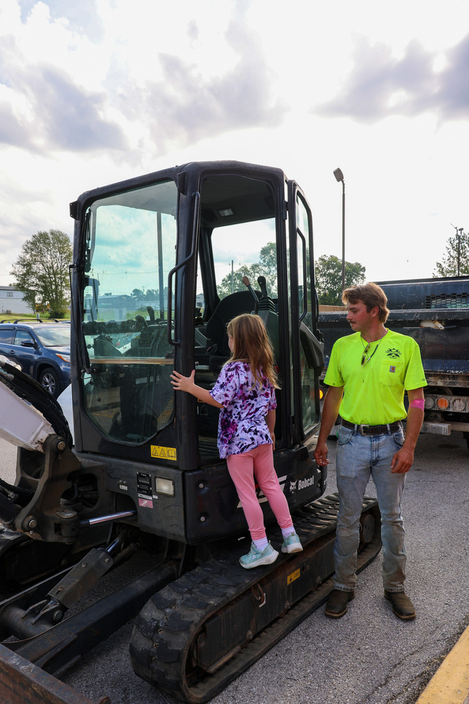 Student steps into a forklift.