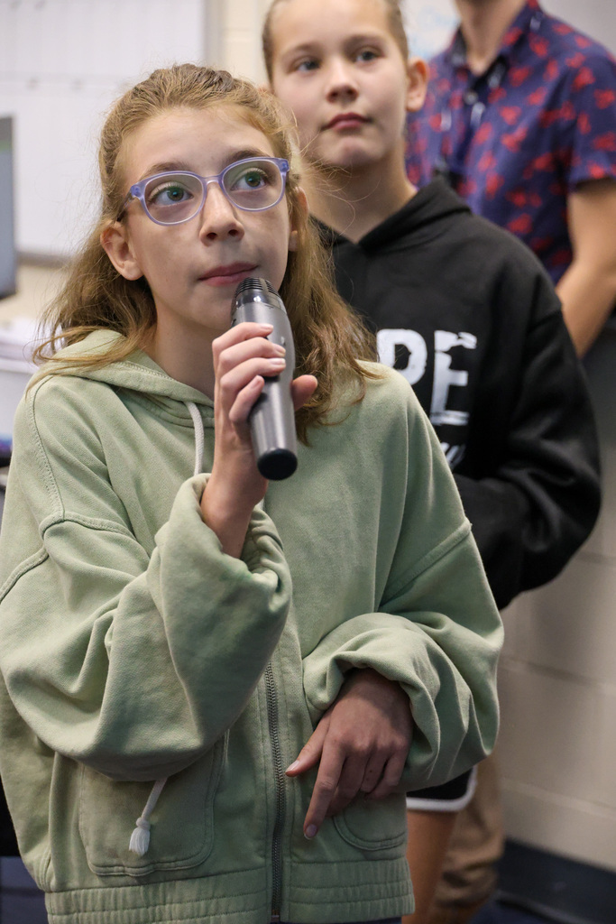 BMS student uses a microphone to perform a short play