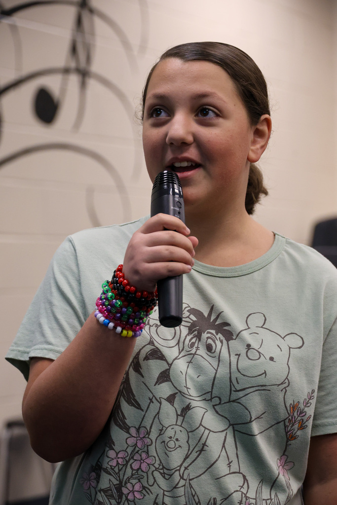 BMS student uses a microphone to perform a short play